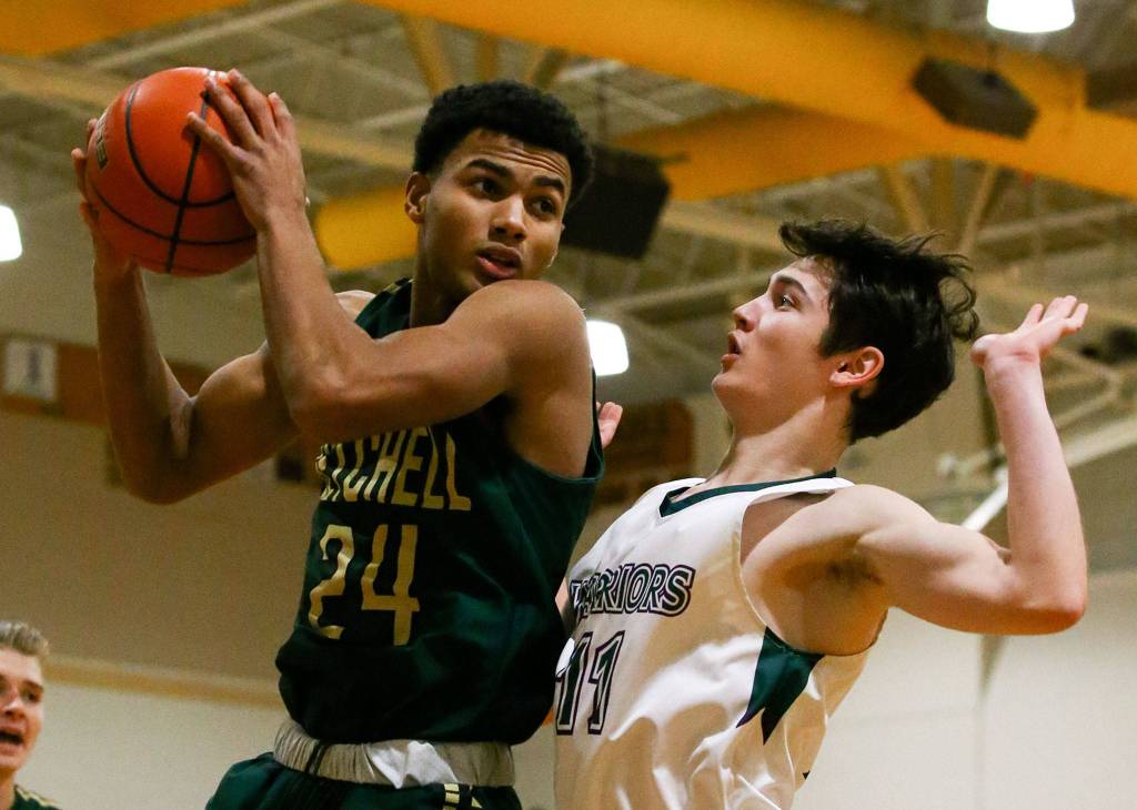 Marysville Getchells Malakhi Knight clutches the ball during a game against Edmonds-Woodway at Edmonds-Woodway High School on January 17, 2020. (Kevin Clark / The Herald)