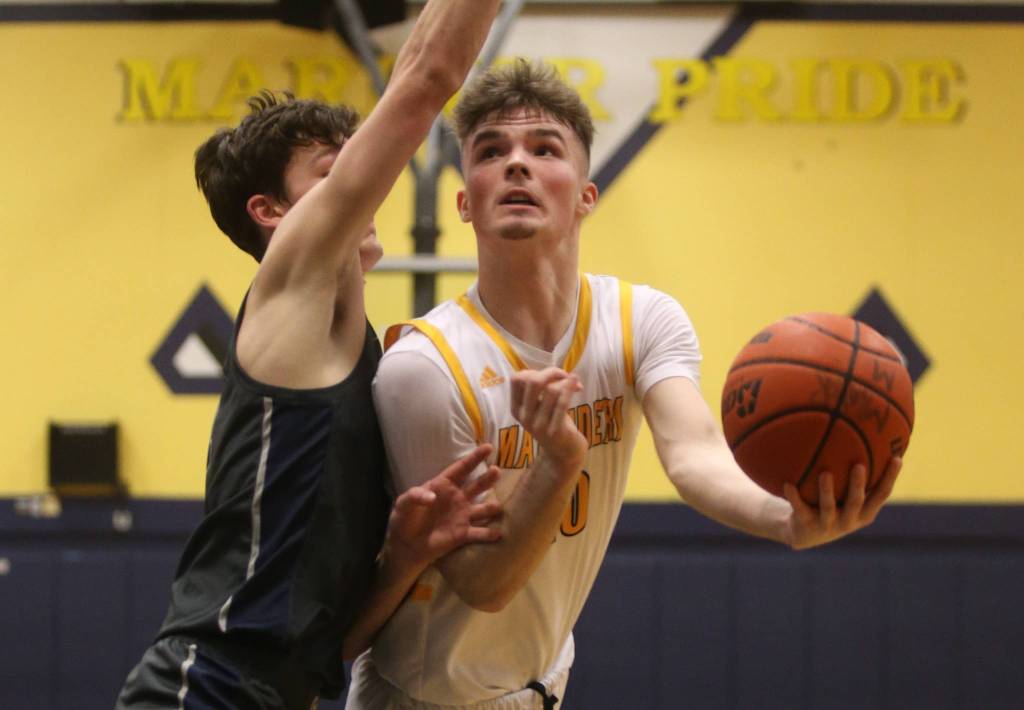 Mariners Roman Savchuk scores a basket under pressure from a Glacier Peak player. Mariner lost to Glacier Peak 90-87 in double overtime in a boys basketball game on Tuesday, Feb. 11, 2020 in Everett, Wash. (Andy Bronson / The Herald)