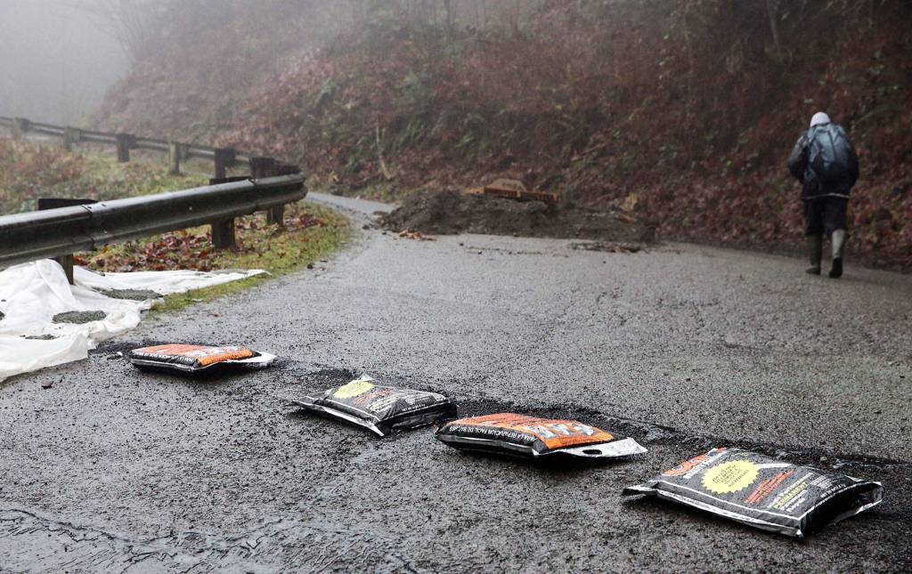 A resident makes his way home on 260th Ave NE leading to Skyview Estate in Monroe on February 13, 2020. (Kevin Clark / The Herald)