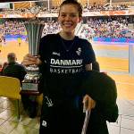 Former Everett High School and Portland State University standout Sidney Rielly holds up the trophy she helped her Danish womens professional basketball team, the Horsholm 79ers, earn for winning the Danish Cup on Feb. 8. (Photo provided)