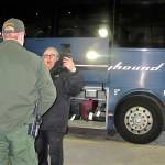 A worker (right) speaks with a Customs and Border Protection agent seeking to board a Greyhound bus headed for Portland, Oregon, at the Spokane Intermodal Center on Thursday. (AP Photo/Nicholas K. Geranios)