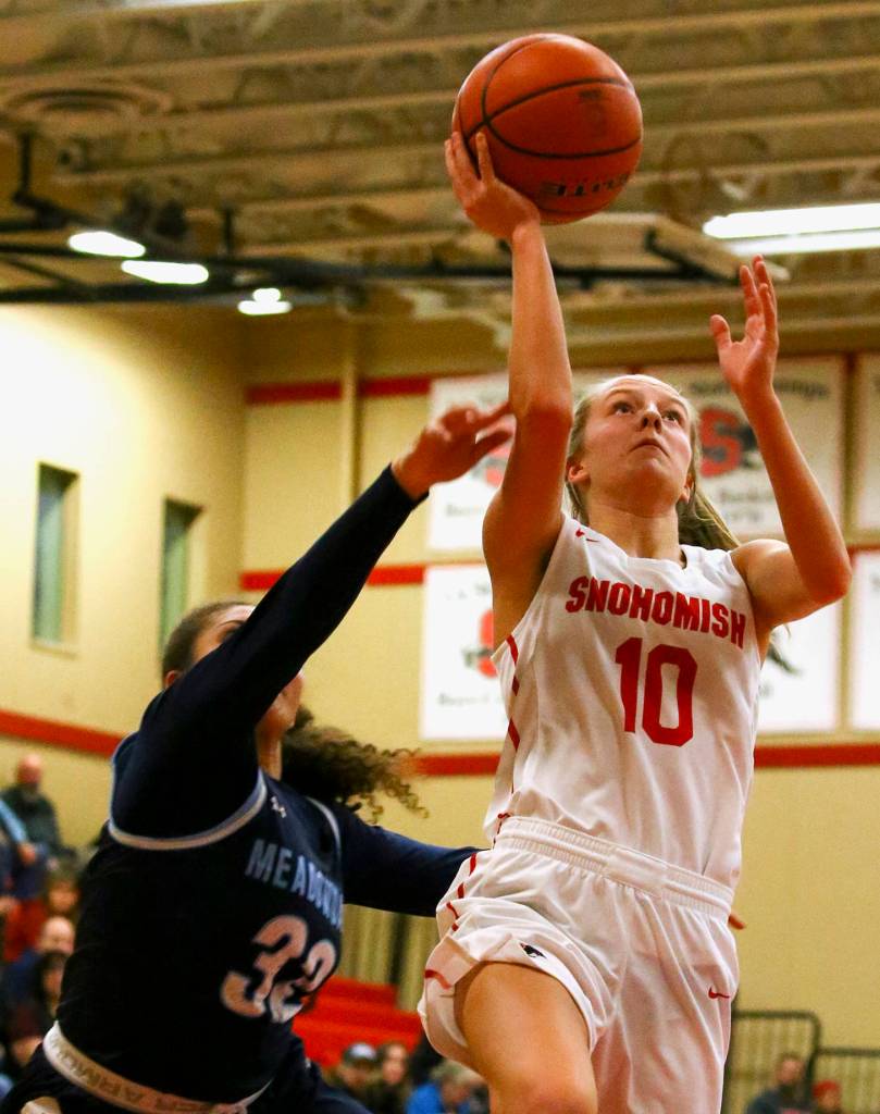 Snohomishs Kalya Soderstrom goes for a layup with Meadowdales Soriah Swinton trailing Friday night at Snohomish High School in Snohomish on February 14, 2020. The Panthers won 57-39. (Kevin Clark / The Herald)