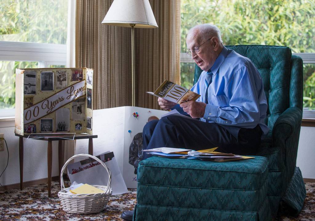 Joe Dwyer reads birthday cards from well-wishers. (Andy Bronson / The Herald)
