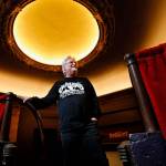 Curt Shriner looks out from behind the balcony rail in the Historic Everett Theatre, which he has managed since 2014. His brother, Curt Shriner, owns the building. (Dan Bates / Herald file)