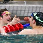 Glacier Peaks Matthew King celebrates with Jensen Elsemore of Jackson at the end of 100-yard freestyle during the 4A NW District Swim Meet on Feb. 15, 2020, at the Snohomish Aquatic Center. (Kevin Clark / The Herald)