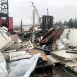 Workers break up the Argosy in January after it washed ashore at Warm Beach. (Global Diving & Salvage)