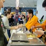 Japanese chef Yuji Kurokawa (right) whose chowder won contests in Japan, offers samples at Edmonds annual chowder cook-off Saturday. (Sharon Salyer / The Herald)