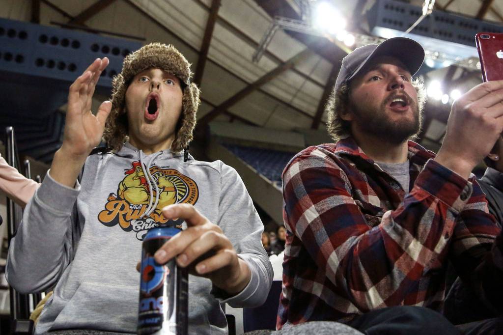 Tyler Deason (left) and Anthony Hall cheer on Sultans Cody Deason during Mat Classic XXXII Friday at the Tacoma Dome on February 21, 2020. (Kevin Clark / The Herald)