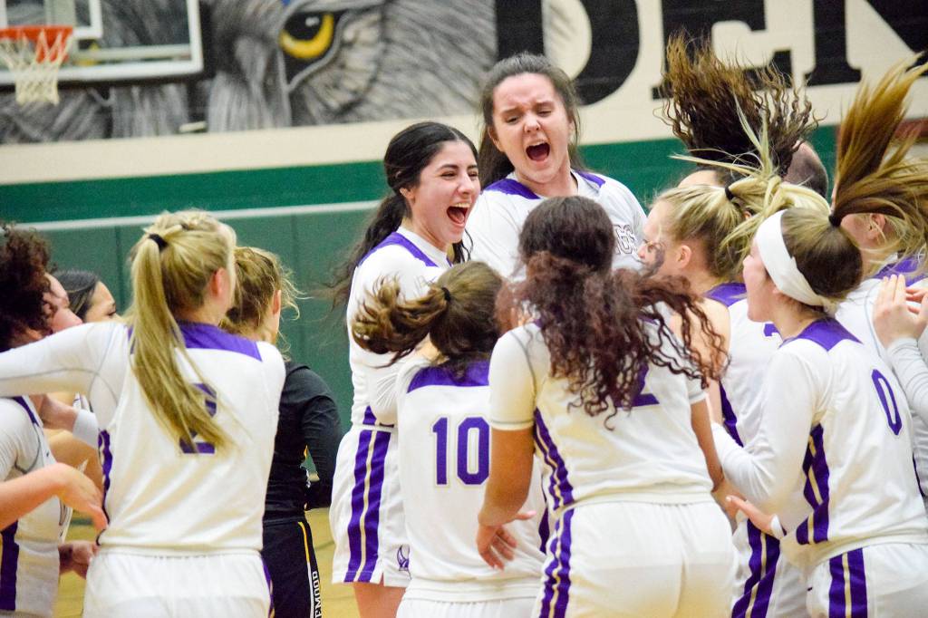 Lake Stevens players celebrate after beating Inglemoor 57-45 in a Wes-King Bi-District Tournament winner-to-state, loser-out game on Thursday at Jackson High School in Mill Creek. (Katie Webber / The Herald)