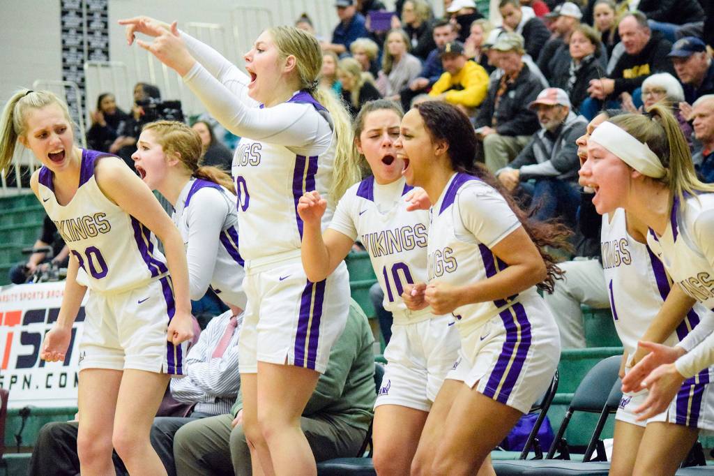 Lake Stevens Carmen Long (30), Isabella Evans (50), Monet Rundle (10), Akili Foster (12), Perla Ruiz (1) and Ella Edens (0) cheer for their team against Inglemoor in a Wes-King Bi-District Tournament winner-to-state, loser-out game on Thursday at Jackson High School in Mill Creek. (Katie Webber / The Herald)