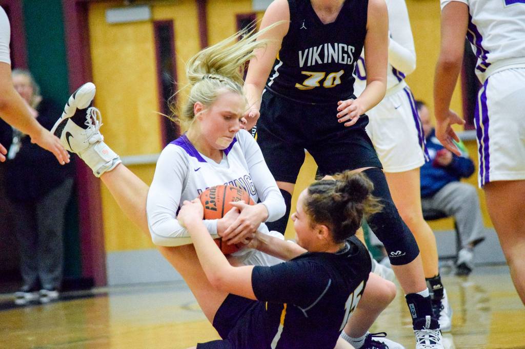 Lake Stevens Chloe Pattison (top) wrestles for the ball against Inglemoors Isabella Reed (bottom) in a Wes-King Bi-District Tournament winner-to-state, loser-out game on Thursday at Jackson High School in Mill Creek. (Katie Webber / The Herald)