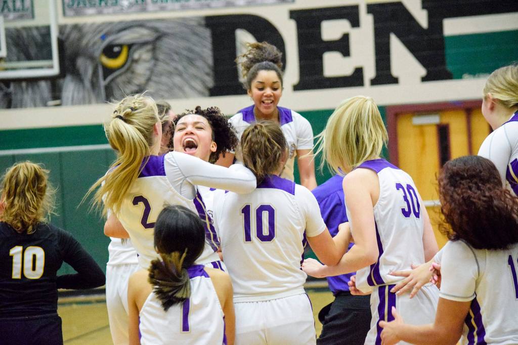 The Lake Stevens girls basketball team celebrates after clinching a state birth with a 57-45 defeat over Inglemoor in a Wes-King Bi-District Tournament winner-to-state, loser-out game on Thursday at Jackson High School in Mill Creek. (Katie Webber / The Herald)