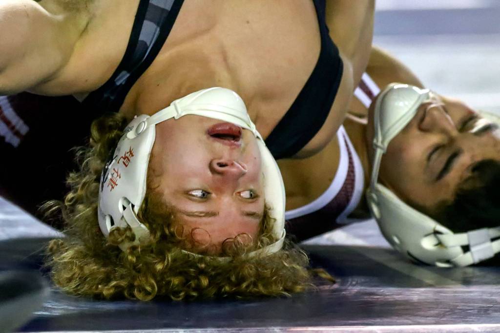 Lake Stevens&rsquo; Aiden Eberlein (left) wrestles South Kitsap&rsquo;s Mitchell Neiner in a 4A 113-pound match on Day 1 of Mat Classic XXXII Friday at the Tacoma Dome. (Kevin Clark / The Herald)
