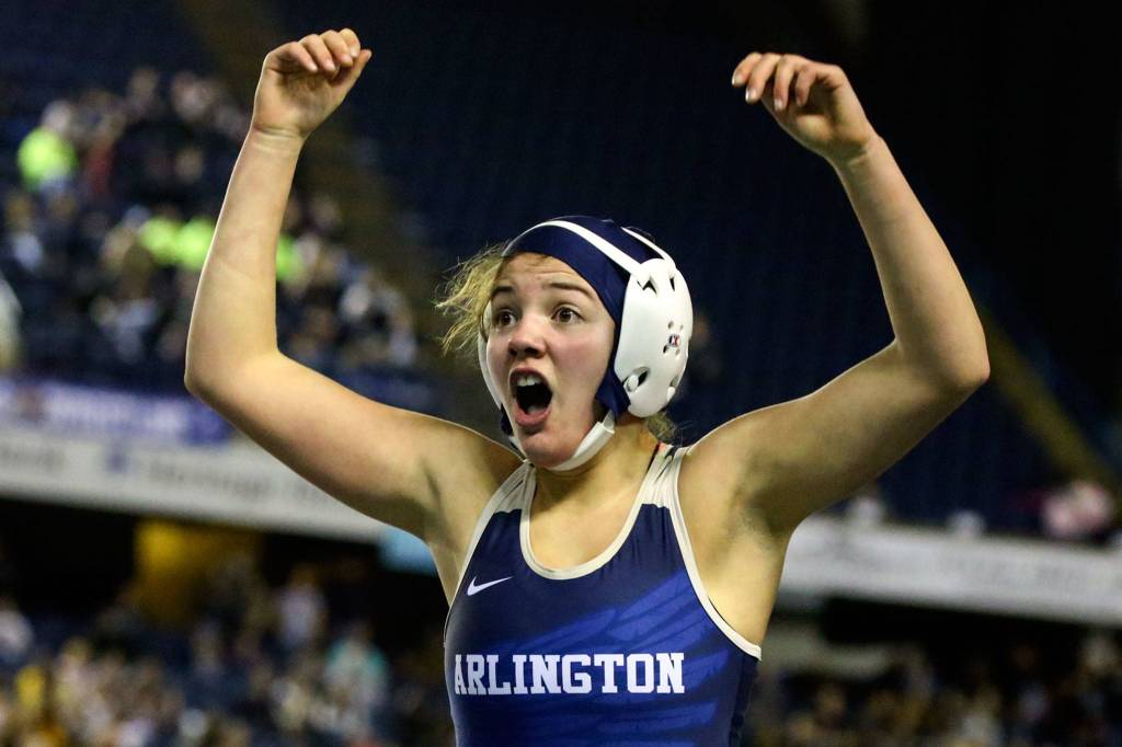 Arlington&rsquo;s Tailer Cochran celebrates after advancing to the 130-pound girls semifinals on Day 1 of Mat Classic XXXII Friday at the Tacoma Dome. (Kevin Clark / The Herald)
