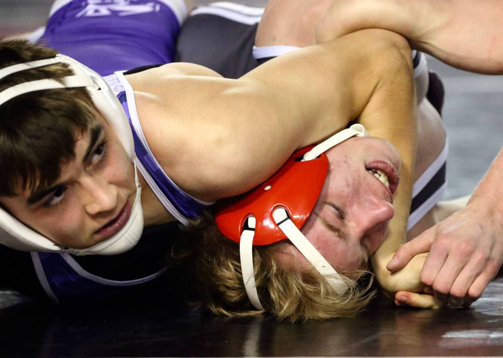 Edmonds-Woodway&rsquo;s Reece LeCompte (left) works to pin Stanwood&rsquo;s Keaton Mayernik during a 3A 120-pound match on Day 1 of Mat Classic XXXII Friday at the Tacoma Dome. (Kevin Clark / The Herald)
