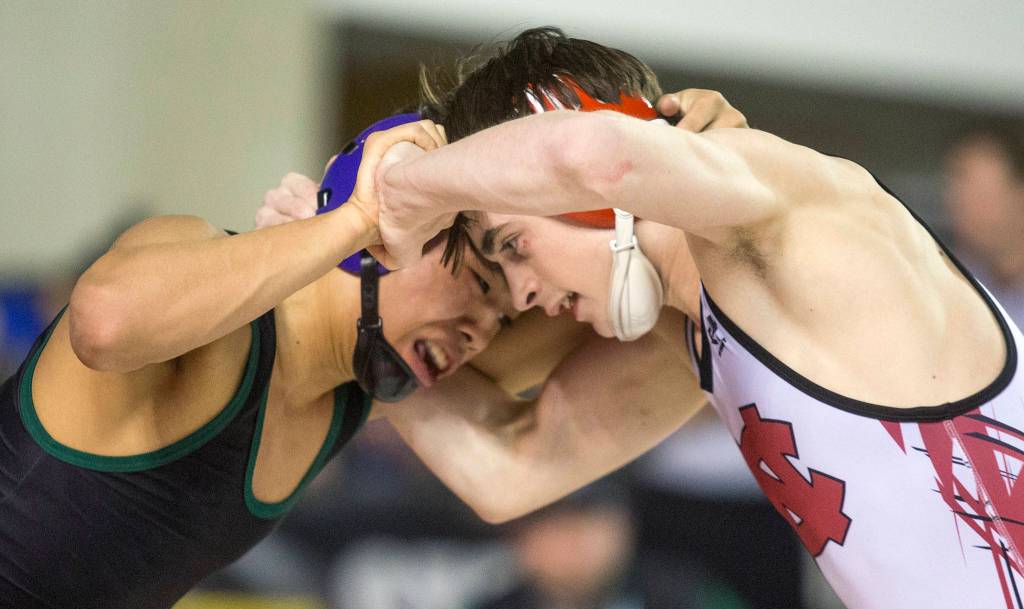 Trying to get the upper hand, Edmonds-Woodways Ethan Nguyen (left) battles North Centrals Steven Zaragoza in the 3A 106-pound title match during Mat Classic XXXII on Saturday at the Tacoma Dome. (Andy Bronson / The Herald)