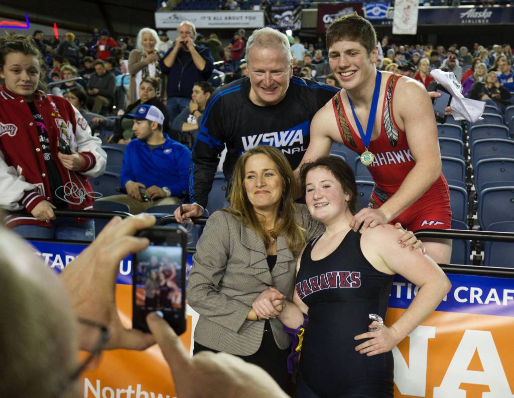 Craig White (top left), Cayden White (top right), Andrea White (lower left) and Alivia White (lower right) take a family photo after Cayden and Alvia won state titles at Mat Classic XXXII on Saturday at the Tacoma Dome. (Andy Bronson / The Herald)
