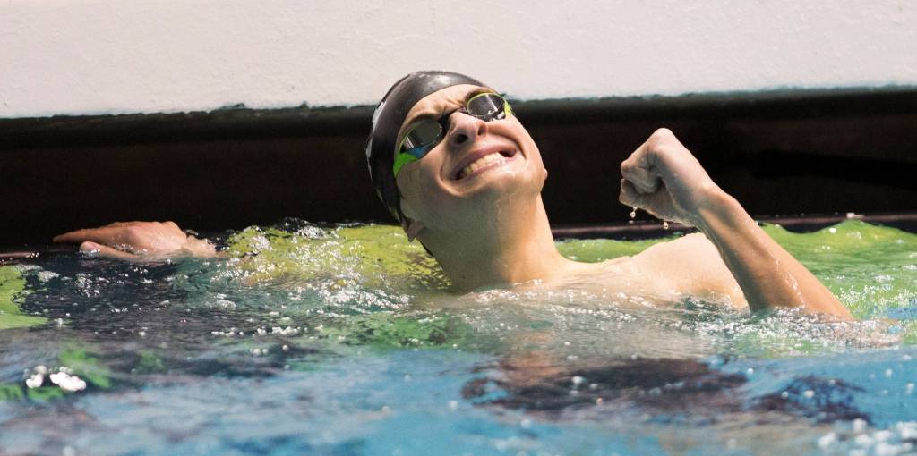 Lake Stevens Alejando Flores reacts after coming in third in the 100 butterfly at the 4A state swim and dive championships on Saturday at the Federal Way Aquatic Center. (Andy Bronson / The Herald)