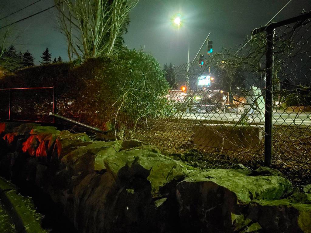 A woman in her 30s allegedly crashed her Nissan Murano off the road, through a fence, and into an Everett Fire Department station on Madison Street on Saturday night. (Everett Fire Department)