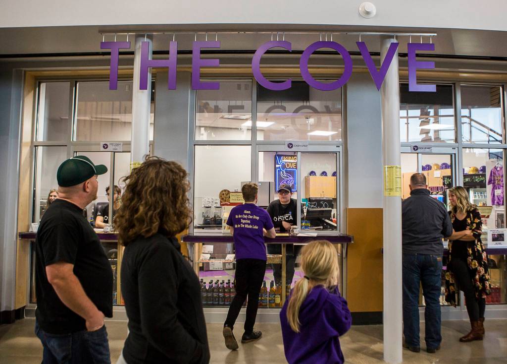 People walk by The Cove, a student store, during the Lake Stevens High School open house on Thursday. (Olivia Vanni / The Herald)