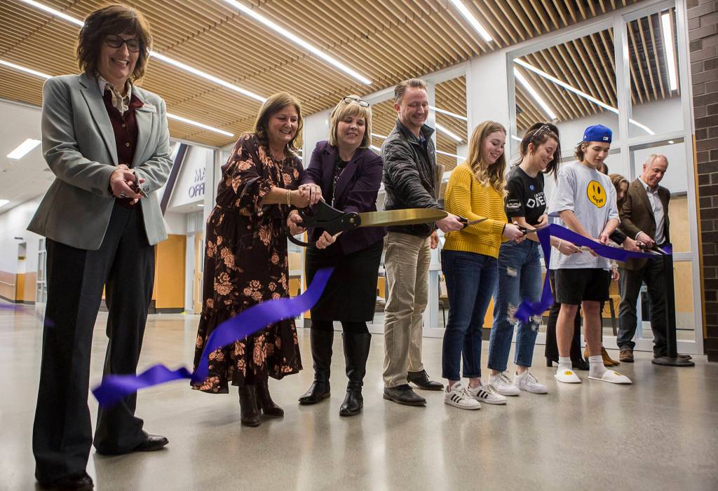 School leaders, students and faculty cut a ribbon durign an opening ceremony at Lake Stevens High School on Thursday. (Olivia Vanni / The Herald)