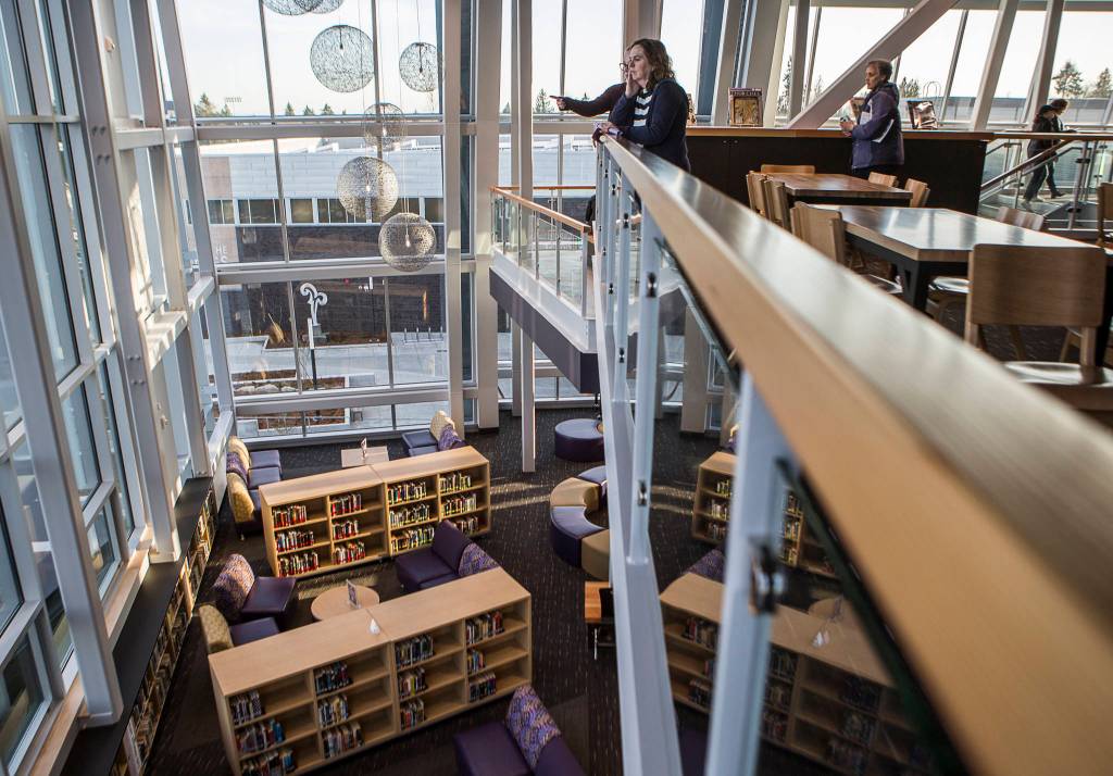 People walk through the new multilevel library during an open house at Lake Stevens High School on Thursday. (Olivia Vanni / The Herald)