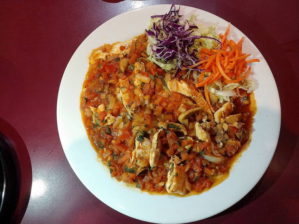 The arroz con pollo at Sol de Mexico is chicken and rice cooked with mushrooms, pico de gallo and tomato juice. (Sara Bruestle / The Herald)
