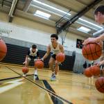 Marysville Getchell junior guard Aiden Verdugo (center) smiles while leading a dribbling drill during practice on Wednesday in Marysville. (Olivia Vanni / The Herald)