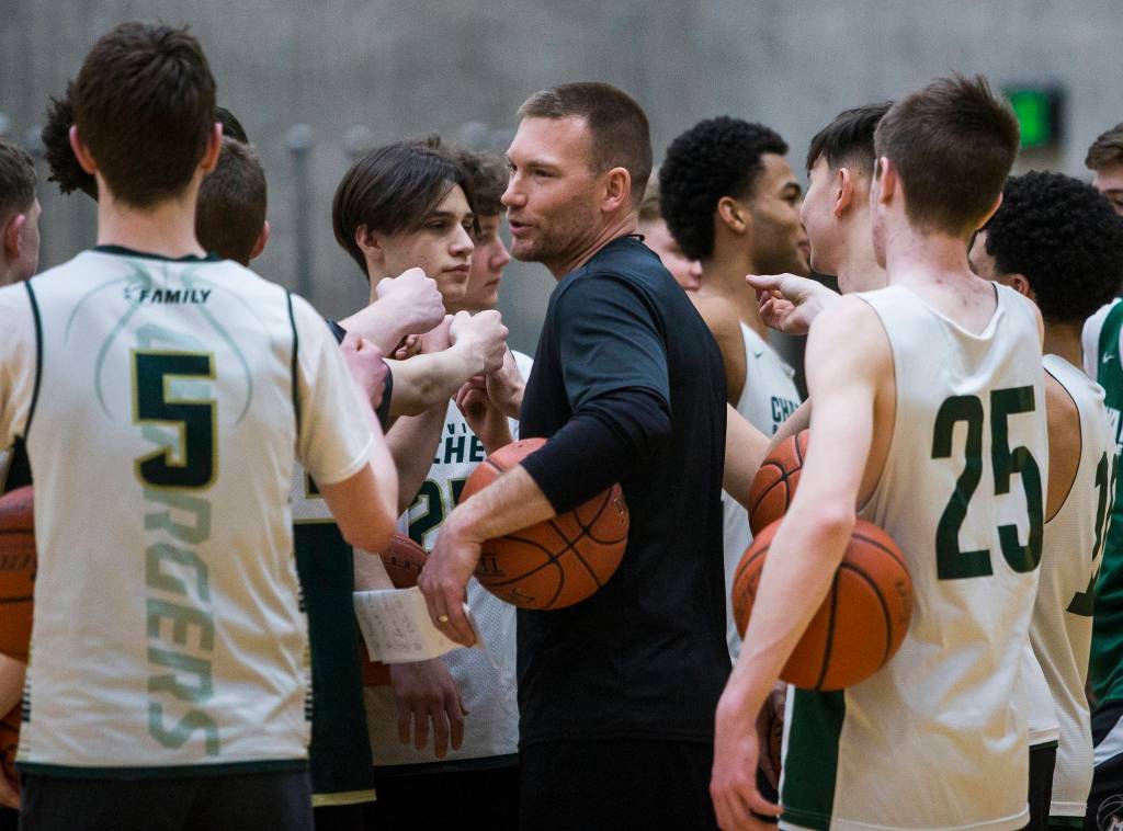 Head coach Corby Schuh cheers with the team during practice on Wednesday, Feb. 26, 2020 in Marysville, Wash. (Olivia Vanni / The Herald)
