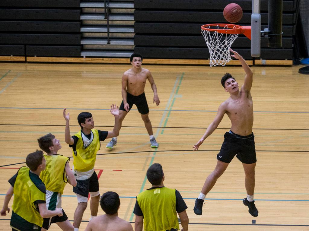 Cameron Banfield jumps for a layup during practice on Wednesday, Feb. 26, 2020 in Marysville, Wash. (Olivia Vanni / The Herald)