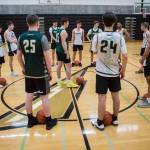 The team gathers at the center of the court before the start of practice on Wednesday, Feb. 26, 2020 in Marysville, Wash. (Olivia Vanni / The Herald)