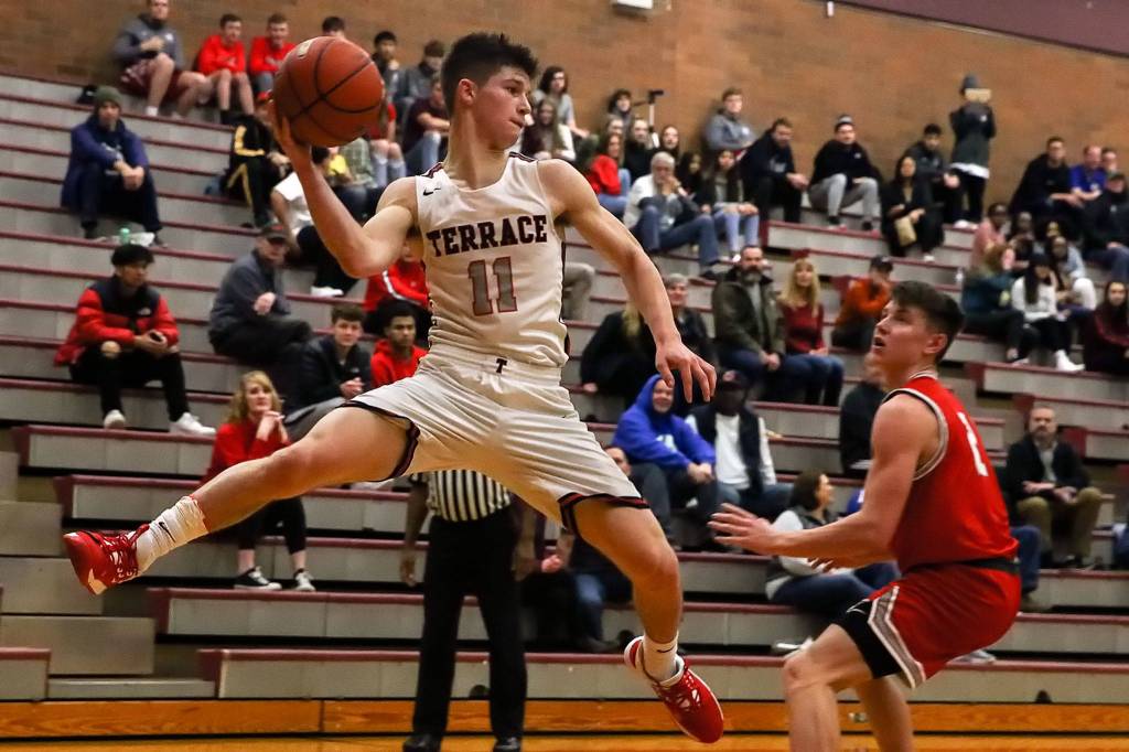Mountlake Terrace&rsquo;s Mason Christianson tries to save a ball from going out of bounds during a Jan. 10 game against Stanwood at Mountlake Terrace High School. (Kevin Clark / The Herald)
