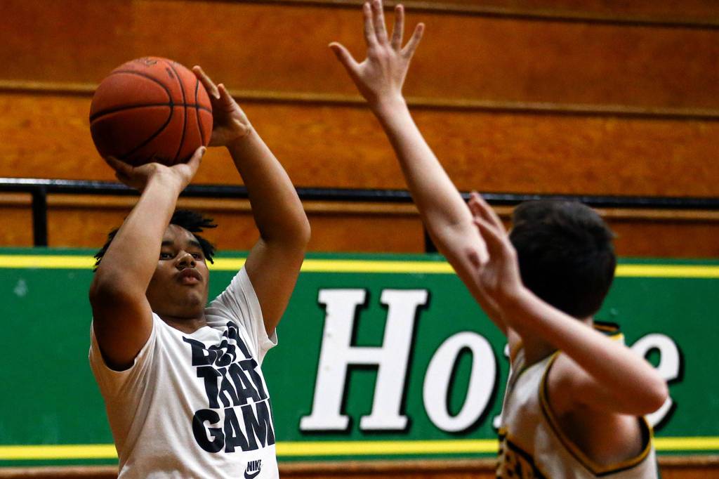 LaRon Nelson attempts a shot during practice Tuesday evening in Darrington on February 25, 2020. (Kevin Clark / The Herald)
