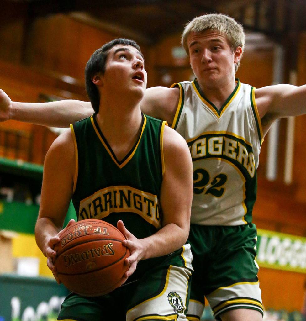 Caleb Rivera looks to score with Aaron Colson defending during practice Tuesday evening in Darrington on February 25, 2020. (Kevin Clark / The Herald)
