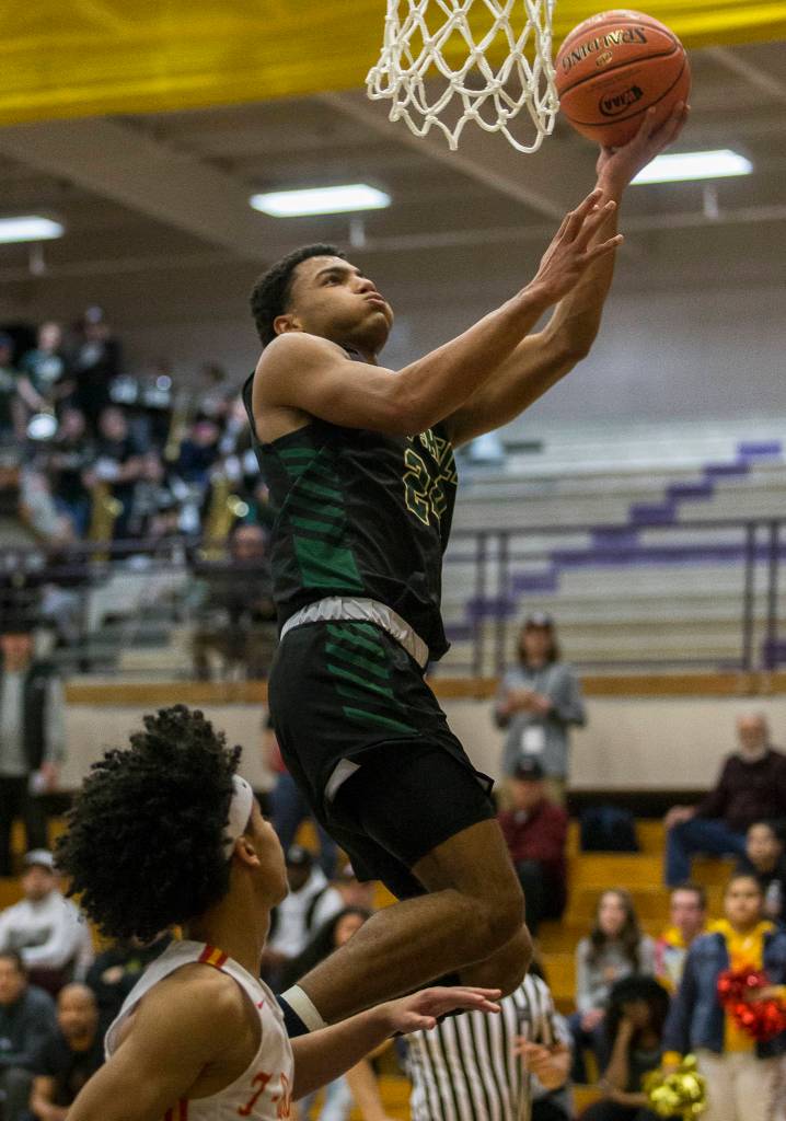 Marysville Getchells Malakhi Knight elevates for a layup during a 3A state regional game against Mount Tahoma on Friday in Puyallup. (Olivia Vanni / The Herald)