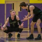Marysville Getchells Josiah Koellmer and Cole Norton talk at half court during the final seconds of a 3A state regional game against Mount Tahoma on Friday in Puyallup. (Olivia Vanni / The Herald)