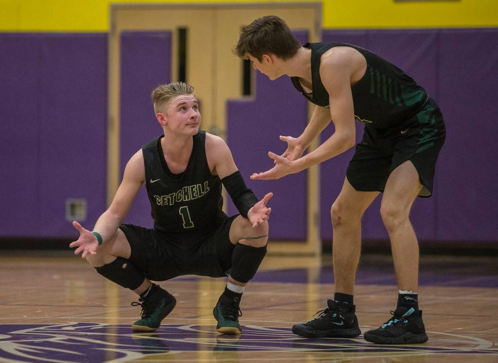 Marysville Getchells Josiah Koellmer and Cole Norton talk at half court during the final seconds of a 3A state regional game against Mount Tahoma on Friday in Puyallup. (Olivia Vanni / The Herald)