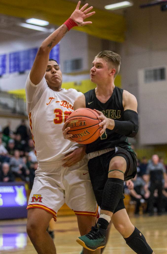 Marysville Getchells Josiah Koellmer drives to the hoop past Mount Tahomas Leo Ruiz during a 3A state regional game on Friday in Puyallup. (Olivia Vanni / The Herald)
