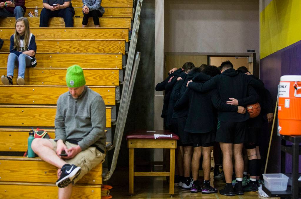 The Marysville Getchell team huddles together before the start of a 3A state regional game against Mount Tahoma on Friday in Puyallup. (Olivia Vanni / The Herald)