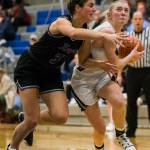 Arlingtons Keira Marsh drives to the hoop past Lake Washingtons Ellie Pederson during the game Saturday, in Shoreline. (Olivia Vanni / The Herald)