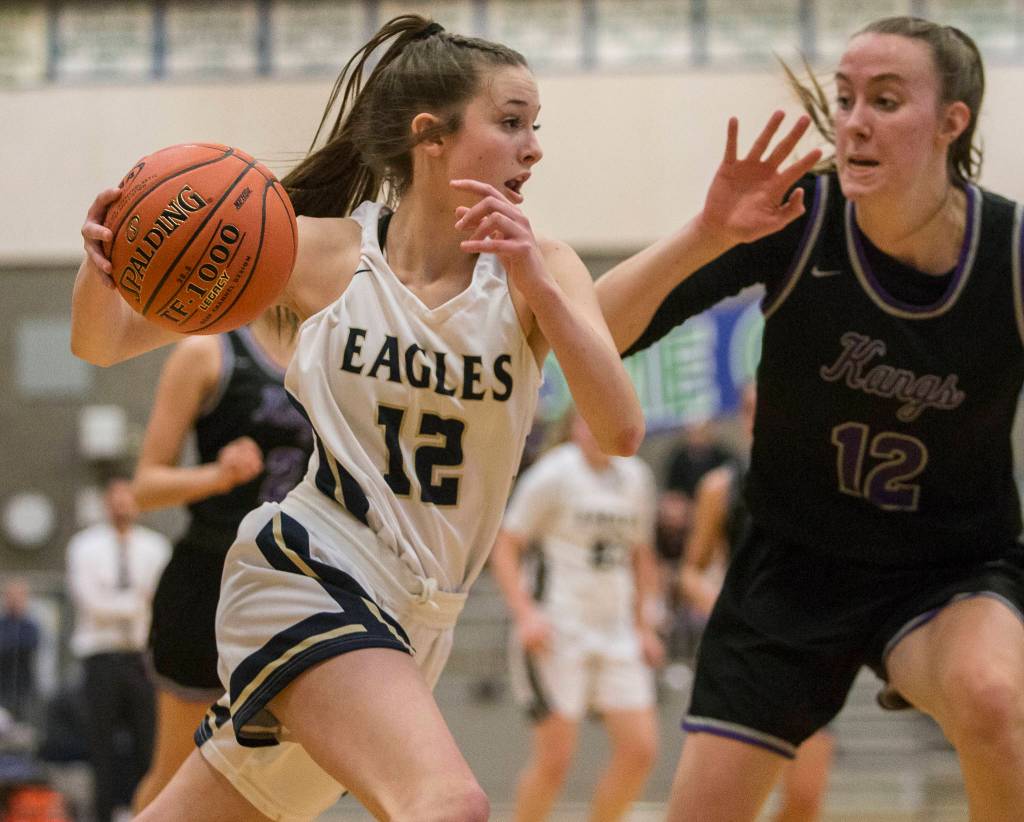 Arlingtons Hannah Rork (12) drives to the hoop during a 3A state regional game against Lake Washington on Saturday in Shoreline. (Olivia Vanni / The Herald)