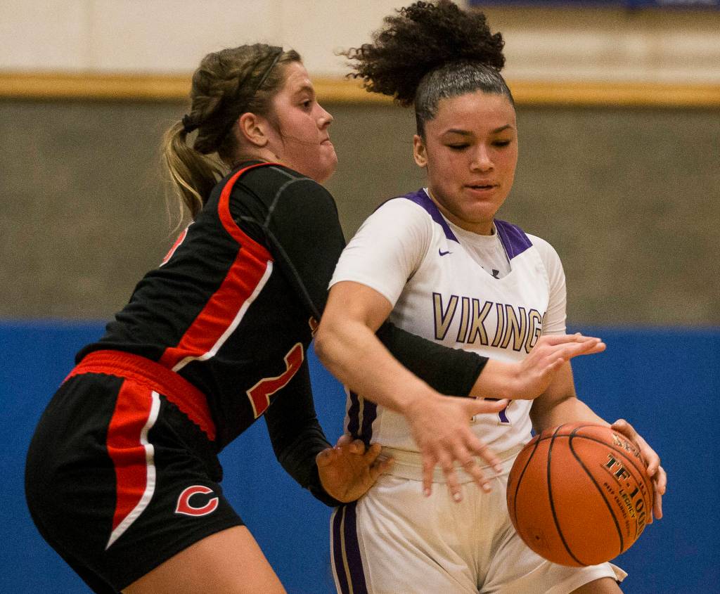 Lake Stevens Baylor Thomas tries to get around Camas Kyra Seggewiss during the game on Saturday, Feb. 29, 2020 in Shoreline, Wa. (Olivia Vanni / The Herald)