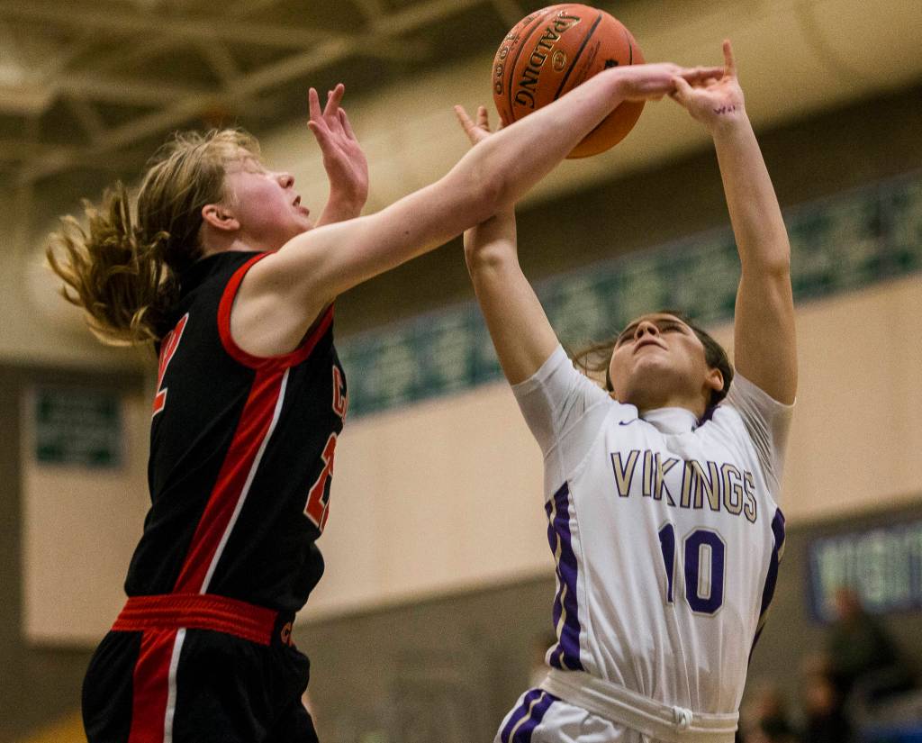 Lake Stevens Monet Rundle gets her shot blocked by Camas Faith Bergstrom during the game on Saturday, Feb. 29, 2020 in Shoreline, Wa. (Olivia Vanni / The Herald)