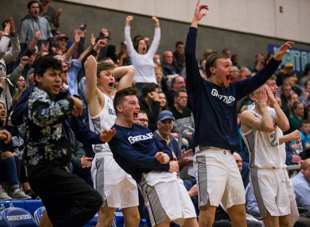 The Glacier Peak bench and fans react to a made 3-point shot during a 4A state regional game against Auburn on Saturday at Shorewood High School in Shoreline. (Olivia Vanni / The Herald)