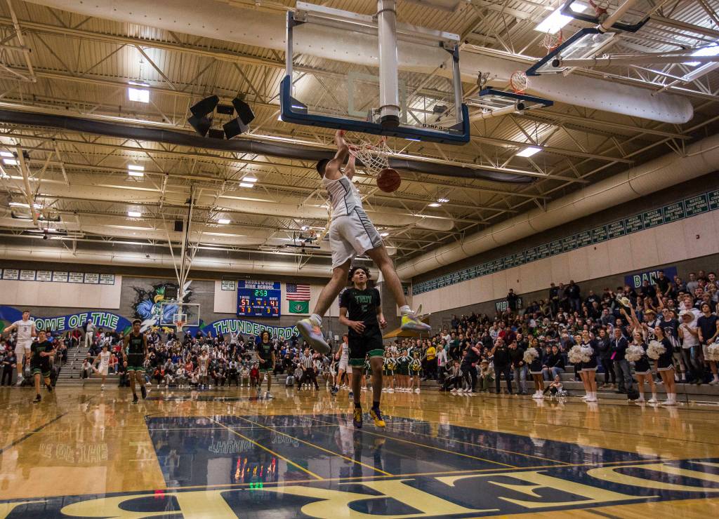 Glacier Peaks Tucker Molina dunks the balls during the final minutes of a 4A state regional game against Auburn on Saturday at Shorewood High School in Shoreline. (Olivia Vanni / The Herald)
