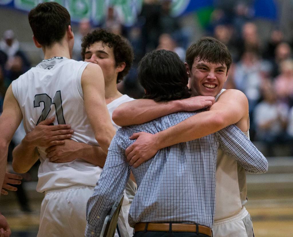 Glacier Peaks players hug after beating Auburn in a 4A state regional game on Saturday at Shorewood High School in Shoreline. (Olivia Vanni / The Herald)