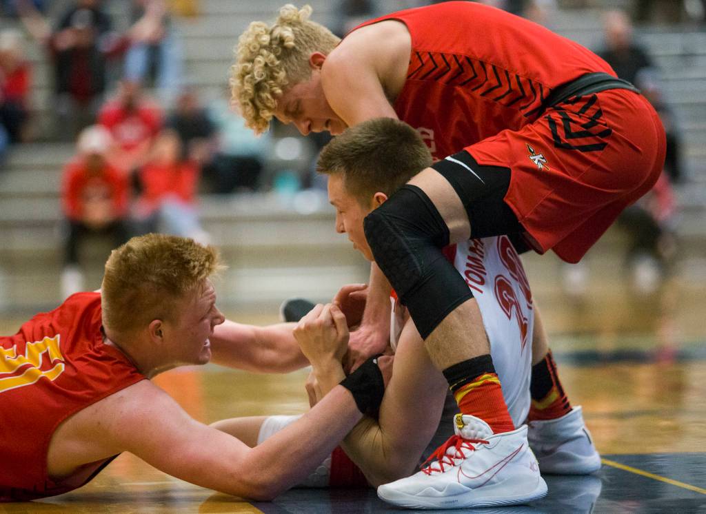 Marysville Pilchucks Luke Dobler scrambles for the ball with Kamiakins Kyson Rose during the game on Saturday, Feb. 29, 2020 in Shoreline, Wa. (Olivia Vanni / The Herald)