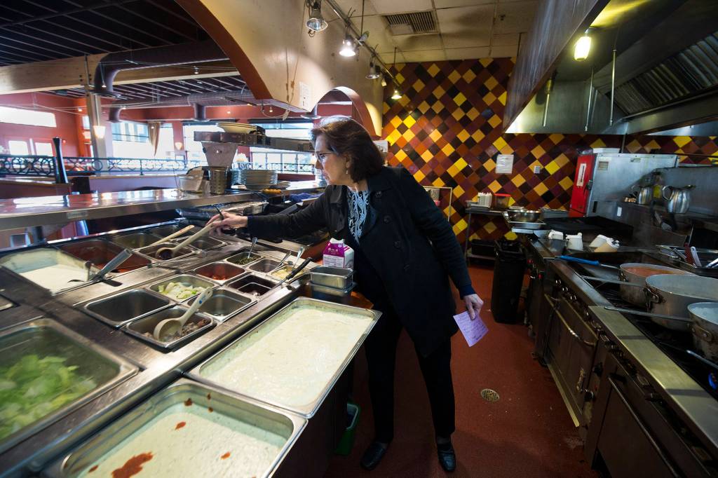 Diane Symms, owner and CEO of Lombardis Italian Restaurants, inspects the kitchen at the Everett location. (Andy Bronson / The Herald)