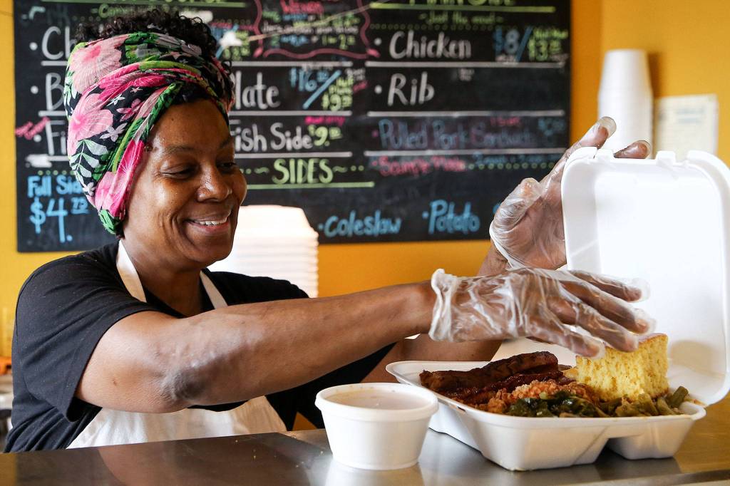 Sharon Tolbert at work in Grandmas in da Kitchen on West Marine View Drive in Everett. She works seven days a week. (Kevin Clark / The Herald)