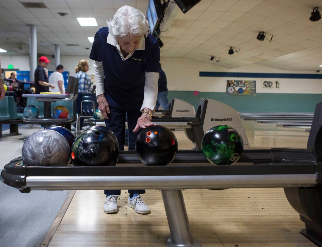 Carol Perry waits for her bowling ball to be returned during league bowling. (Olivia Vanni / The Herald)